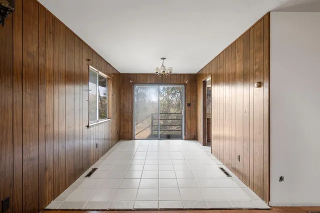 a kitchen with stainless steel appliances a sink a stove a refrigerator cabinets and a window