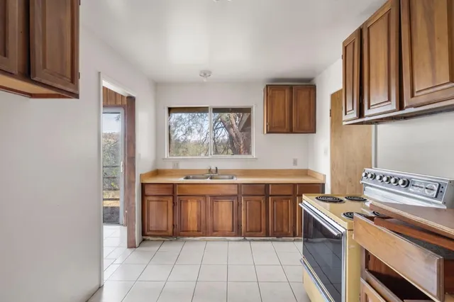 a kitchen with a stove top oven sink and cabinets