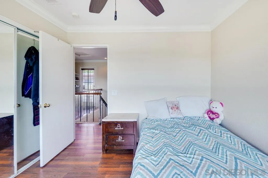320 Grapevine Road, Unit 12 Vista, CA 92083 - Photo 44 of 50 a bedroom with a bed and a wooden floor
