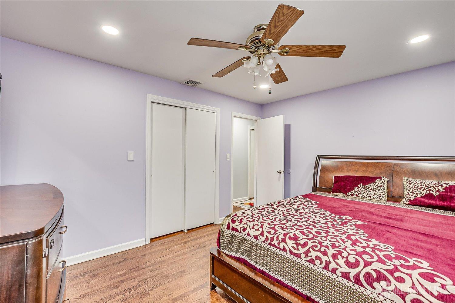 149 Vineyard Road Edison, NJ 08817 - Photo 18 of 40 a bedroom with a large bed and a chandelier