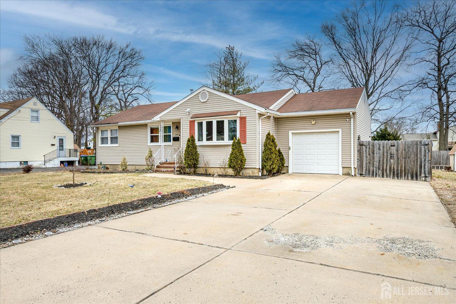 149 Vineyard Road Edison, NJ 08817 - Photo 3 of 40 a view of a white house with a large tree next to a yard