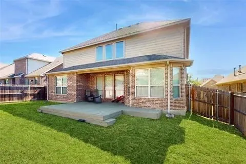 a view of a house with a yard and sitting area