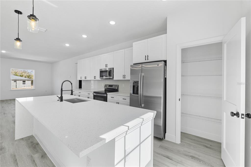 2640 West Fairway Loop Citrus Springs, FL 34434 - Photo 15 of 39 a kitchen with a refrigerator and a sink
