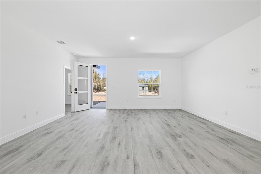 2640 West Fairway Loop Citrus Springs, FL 34434 - Photo 19 of 39 an empty room with a hardwood and wooden floor