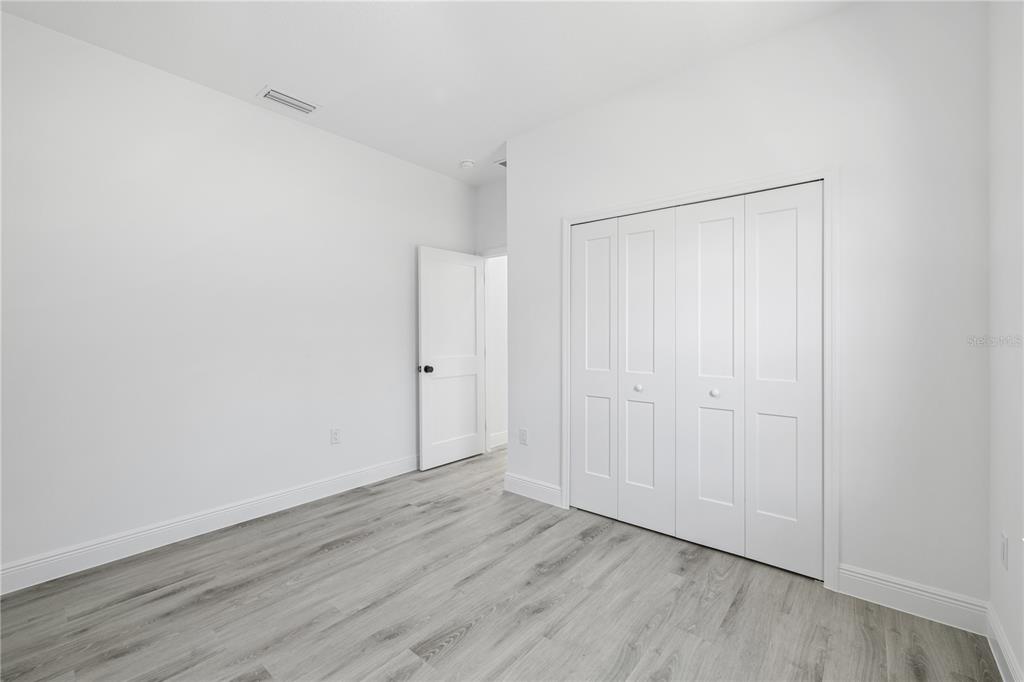 2640 West Fairway Loop Citrus Springs, FL 34434 - Photo 23 of 39 a view of an empty room with wooden floor
