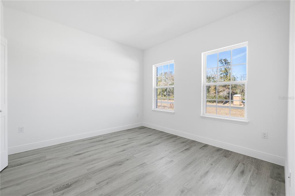 2640 West Fairway Loop Citrus Springs, FL 34434 - Photo 25 of 39 an empty room with wooden floor and window