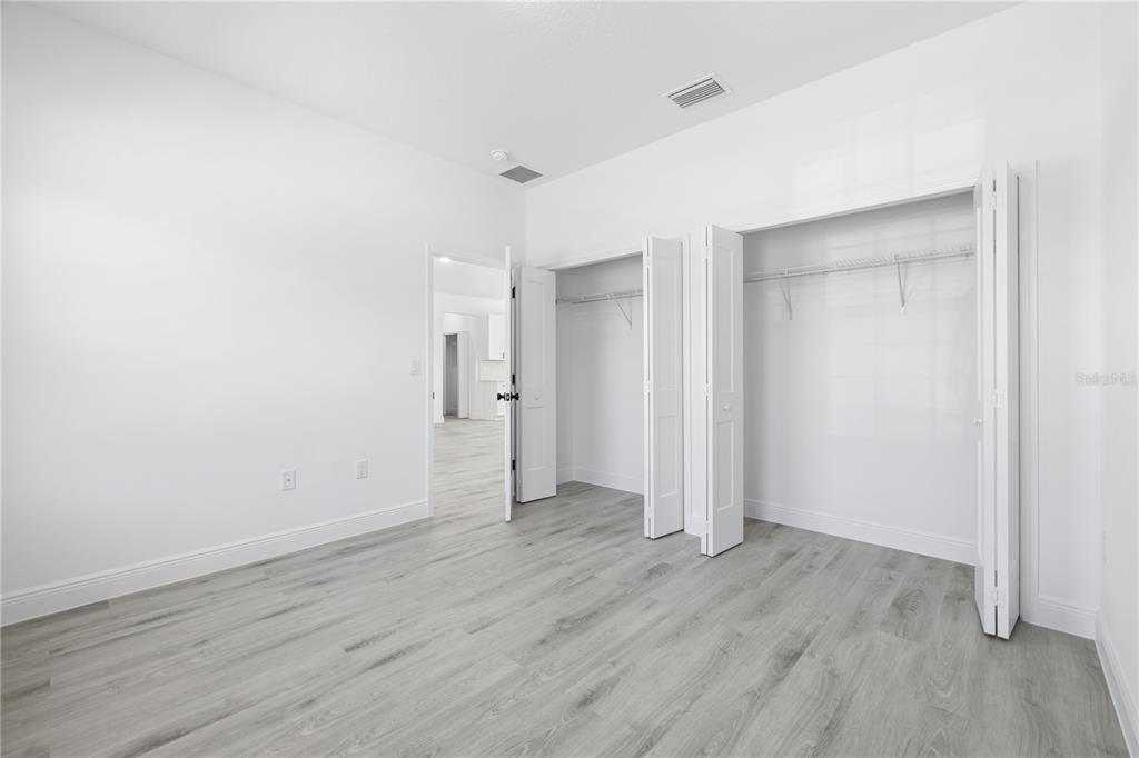 2640 West Fairway Loop Citrus Springs, FL 34434 - Photo 26 of 39 an empty room with wooden floor & closet area