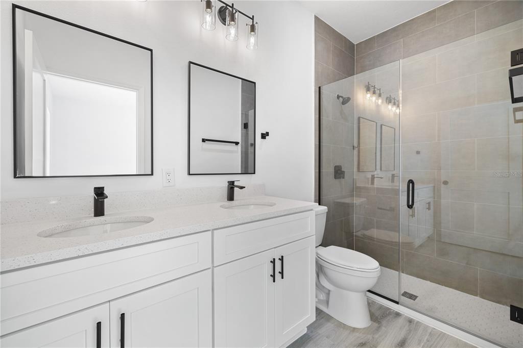 2640 West Fairway Loop Citrus Springs, FL 34434 - Photo 8 of 39 a bathroom with a toilet sink vanity granite and shower