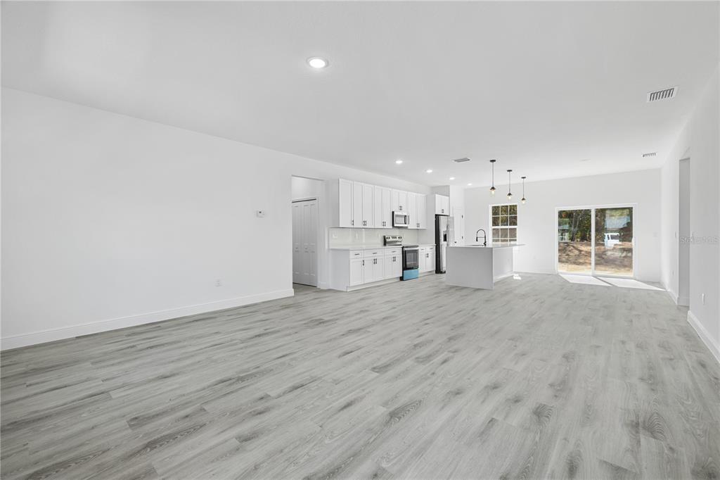 2640 West Fairway Loop Citrus Springs, FL 34434 - Photo 10 of 39 a view of a kitchen with a microwave and wooden floor