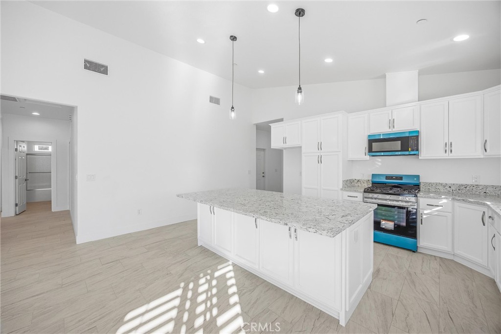 11788 Buckwheat Road Pinon Hills, CA 92371 - Photo 11 of 61 a large kitchen with stainless steel appliances granite countertop a stove a sink and a refrigerator