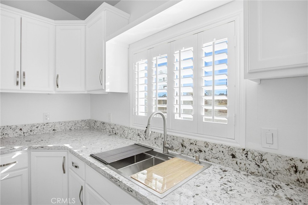 11788 Buckwheat Road Pinon Hills, CA 92371 - Photo 13 of 61 a kitchen with a stove a sink and white cabinets