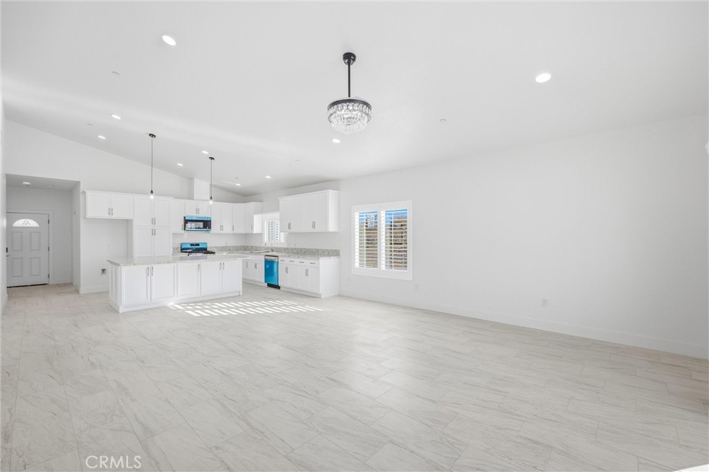 11788 Buckwheat Road Pinon Hills, CA 92371 - Photo 18 of 61 a view of a kitchen with refrigerator and windows