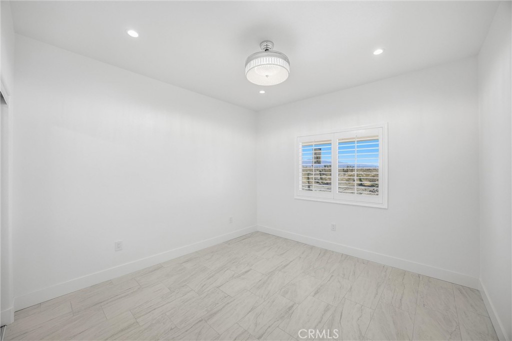 11788 Buckwheat Road Pinon Hills, CA 92371 - Photo 19 of 61 an empty room with a window