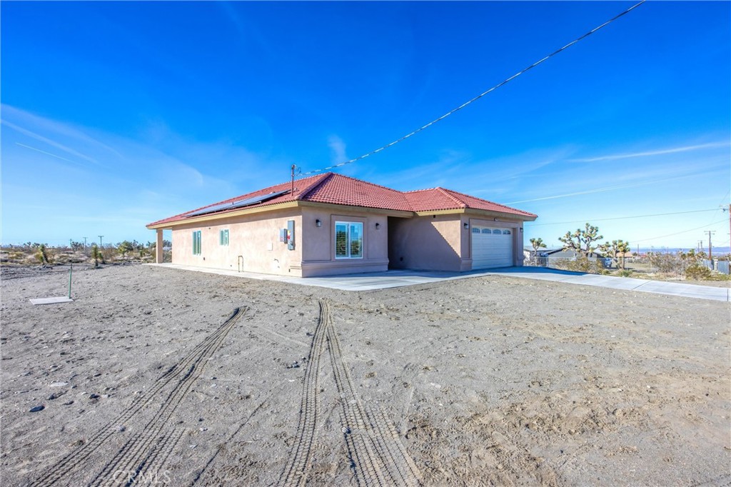 11788 Buckwheat Road Pinon Hills, CA 92371 - Photo 2 of 61 a front view of a house with a yard