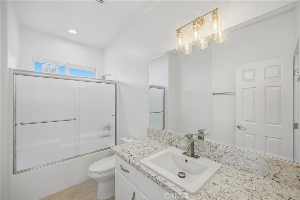 11788 Buckwheat Road Pinon Hills, CA 92371 - Photo 23 of 61 a bathroom with a sink vanity granite toilet and shower