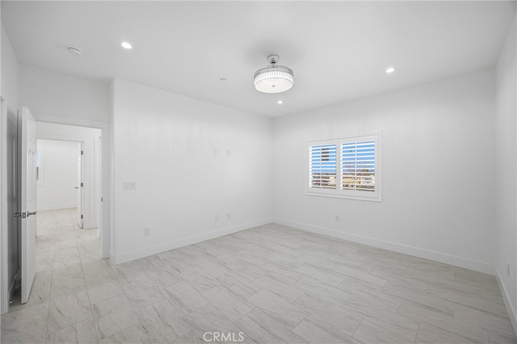 11788 Buckwheat Road Pinon Hills, CA 92371 - Photo 26 of 61 an empty room with a fan & a window