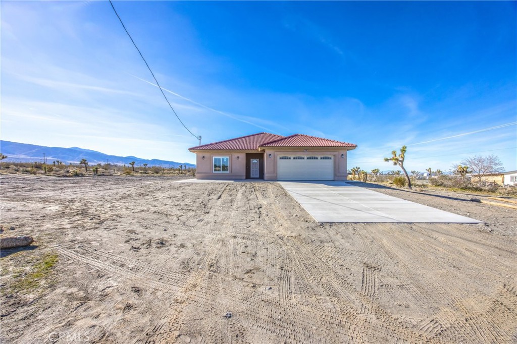 11788 Buckwheat Road Pinon Hills, CA 92371 - Photo 3 of 61 a front view of a house with a yard