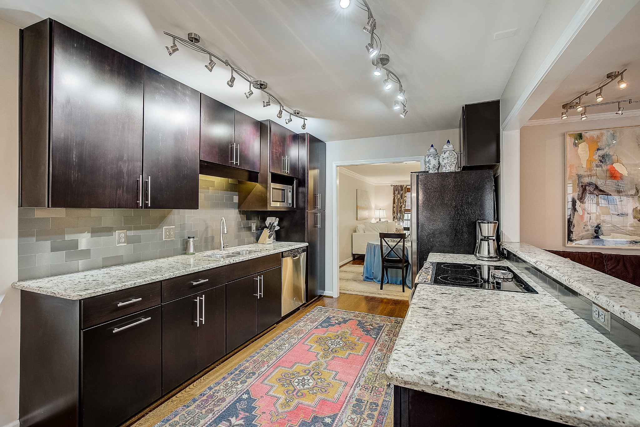 1284 General George Patton Road Nashville, TN 37221 - Photo 12 of 30 a kitchen with granite countertop stainless steel appliances a sink stove top oven and cabinets