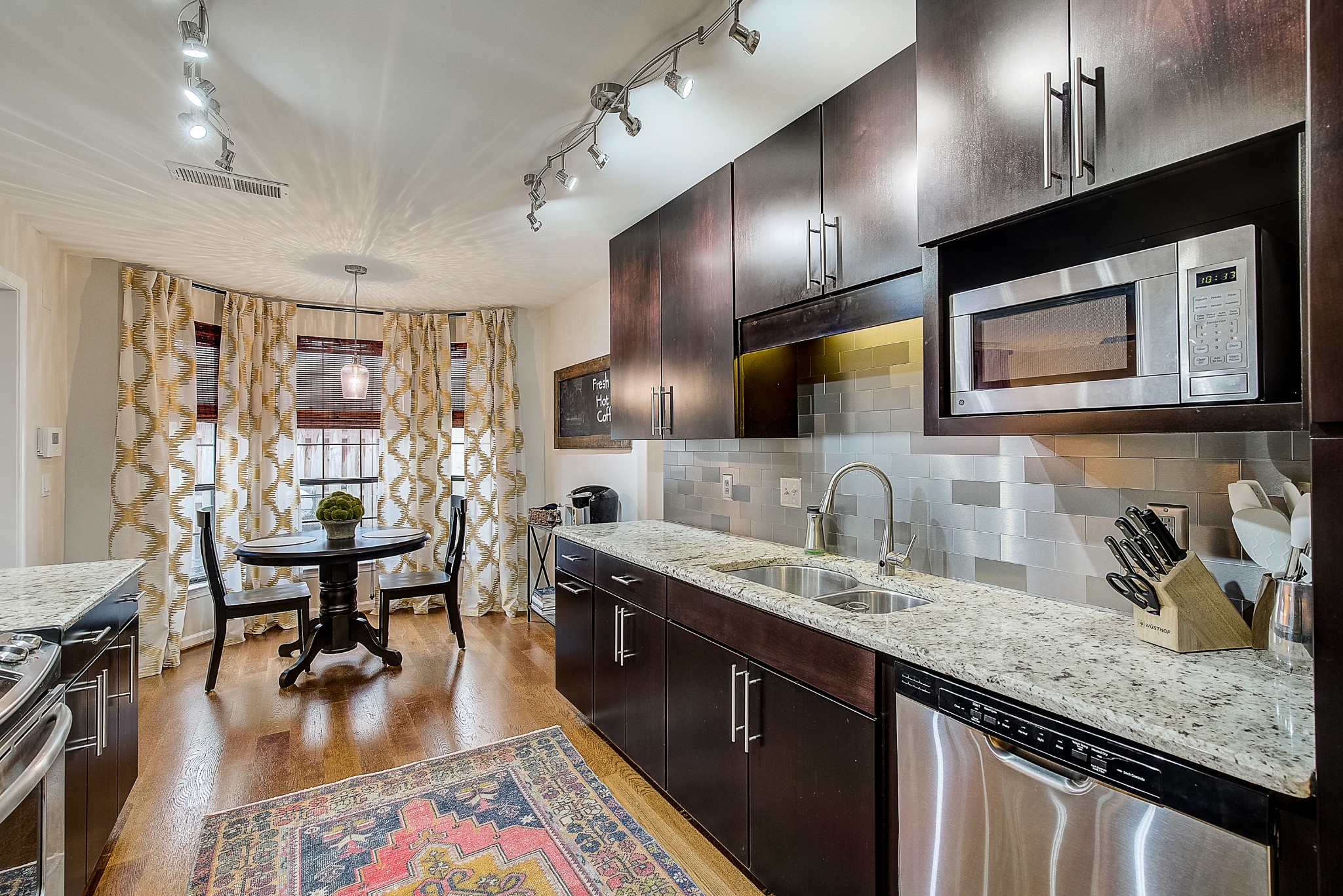 1284 General George Patton Road Nashville, TN 37221 - Photo 14 of 30 a kitchen with lots of counter space a sink appliances and living room view