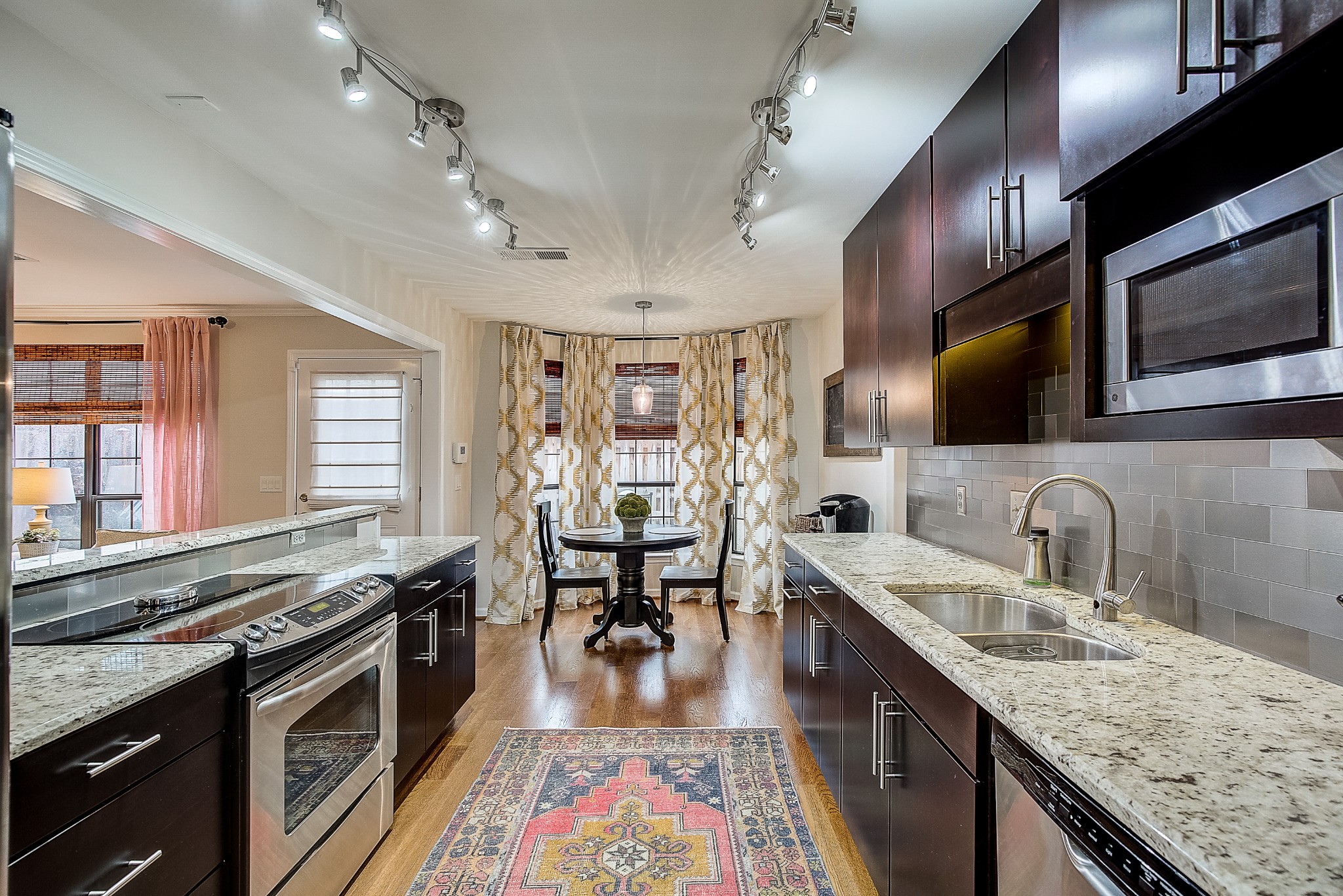 1284 General George Patton Road Nashville, TN 37221 - Photo 15 of 30 a kitchen with stainless steel appliances granite countertop a sink stove and refrigerator