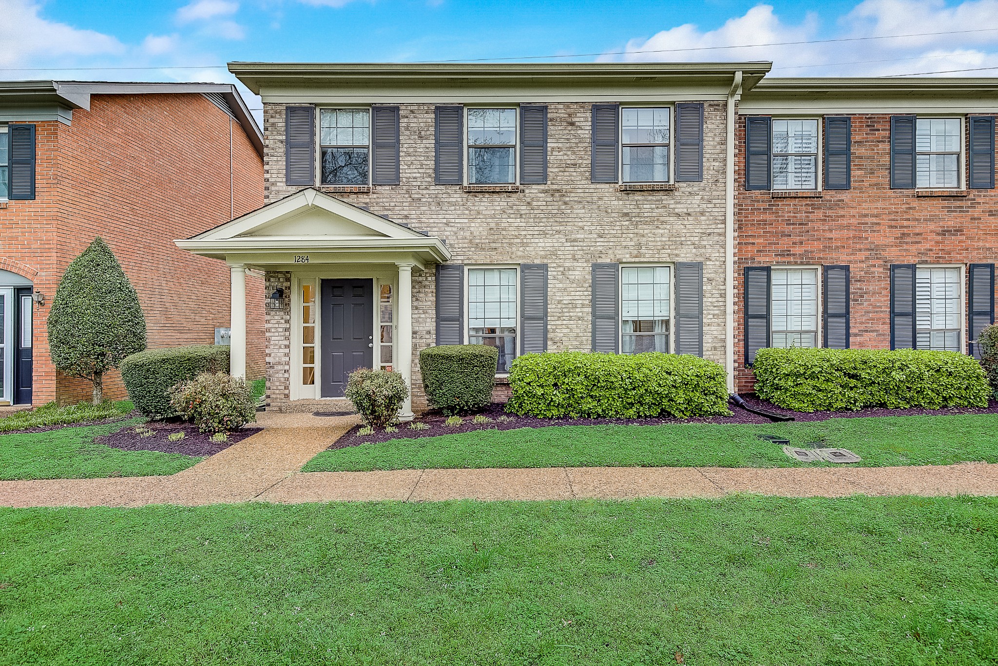 1284 General George Patton Road Nashville, TN 37221 - Photo 2 of 30 a front view of a house with a yard and garage