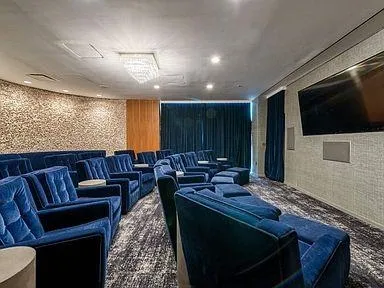 a living room with furniture a flat screen tv and a large window