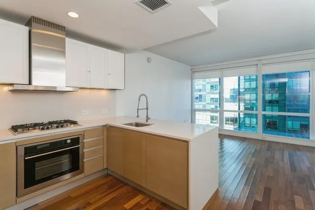 a kitchen with a stove a sink and a refrigerator