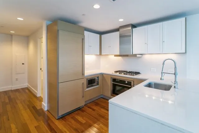 a kitchen with a sink a stove and a refrigerator