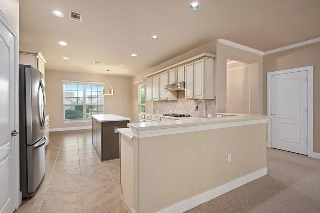 a kitchen with stainless steel appliances a sink stove and refrigerator