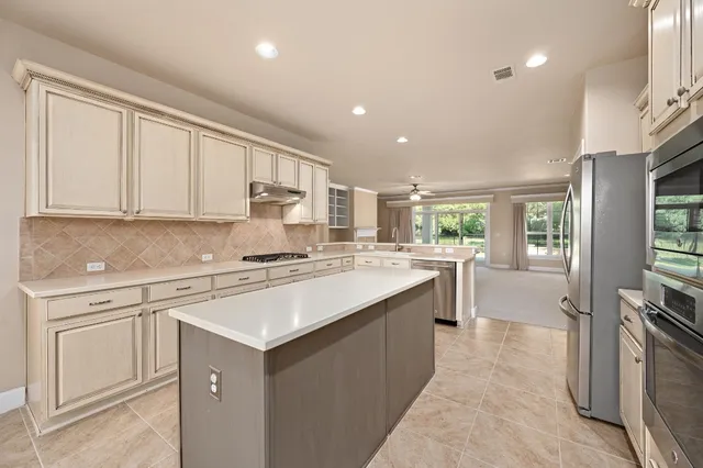 a kitchen with a sink stove and cabinets