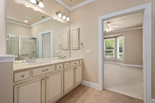 a bathroom with a double vanity sink and a mirror