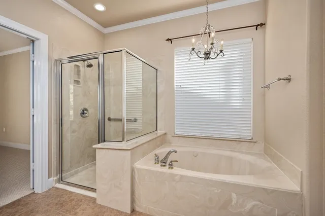 a bathroom with a granite countertop sink a mirror a bathtub and shower