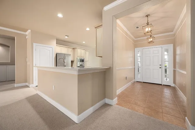 a view of a kitchen with refrigerator and a sink