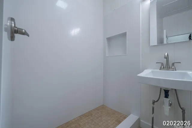a bathroom with a sink a light fixture and a toilet