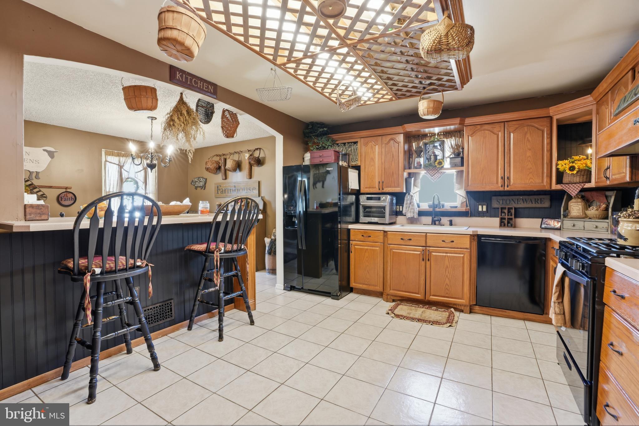 118 West Clinton Street Clayton, NJ 08312 - Photo 8 of 30 a kitchen with stainless steel appliances kitchen island granite countertop a table chairs in it and a window