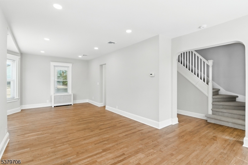 45 Oakridge Road West Orange, NJ 07052 - Photo 11 of 35 a view of an empty room with wooden floor and staircase