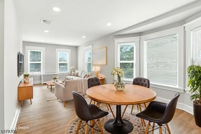 a view of a dining room with furniture and wooden floor