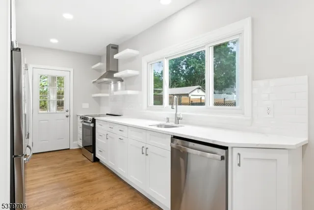 a kitchen with a sink and large window