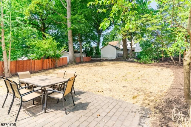 a front view of a house with a yard and sitting area
