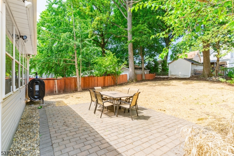 45 Oakridge Road West Orange, NJ 07052 - Photo 34 of 35 a view of a backyard with table and chairs with wooden fence and plants