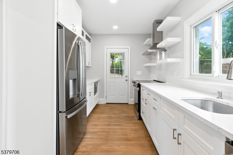 45 Oakridge Road West Orange, NJ 07052 - Photo 4 of 35 a kitchen with granite countertop a refrigerator and a sink