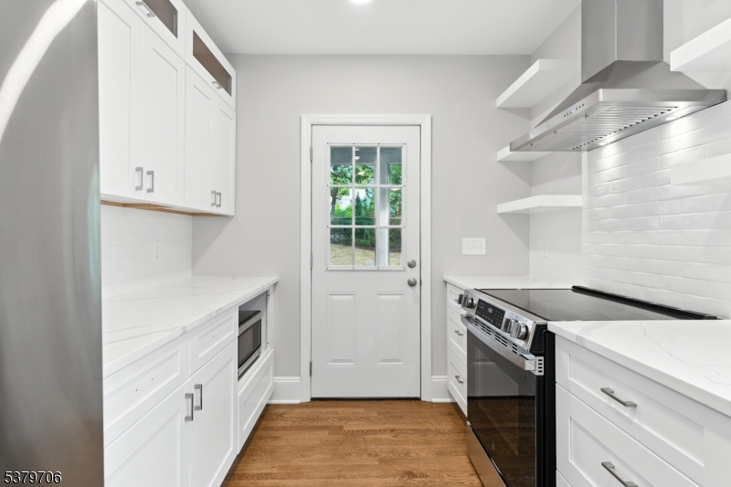 45 Oakridge Road West Orange, NJ 07052 - Photo 6 of 35 a kitchen with a stove and a white refrigerator