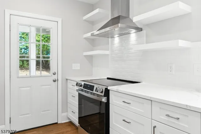 a kitchen with white cabinets and white appliances