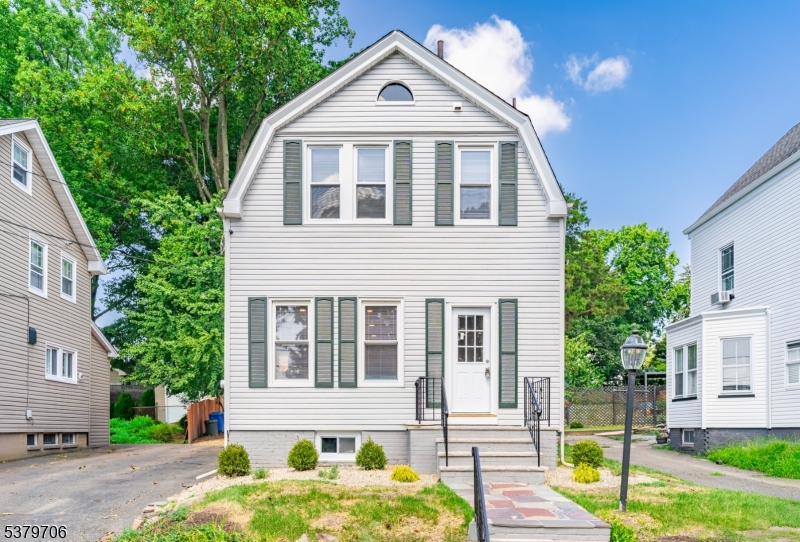 45 Oakridge Road West Orange, NJ 07052 - Photo 8 of 35 a view of a yard in front of a brick house with large windows
