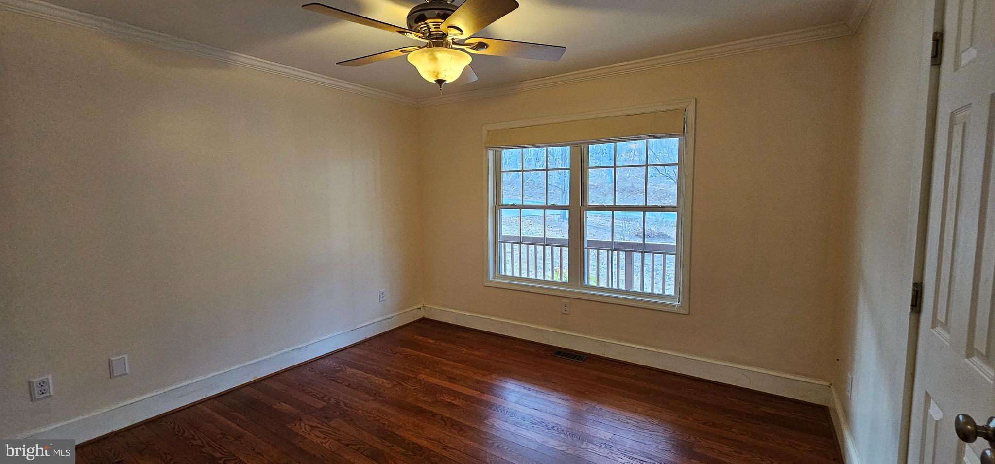 4078 Panhandle Road Front Royal, VA 22630 - Photo 11 of 23 an empty room with wooden floor fan and windows