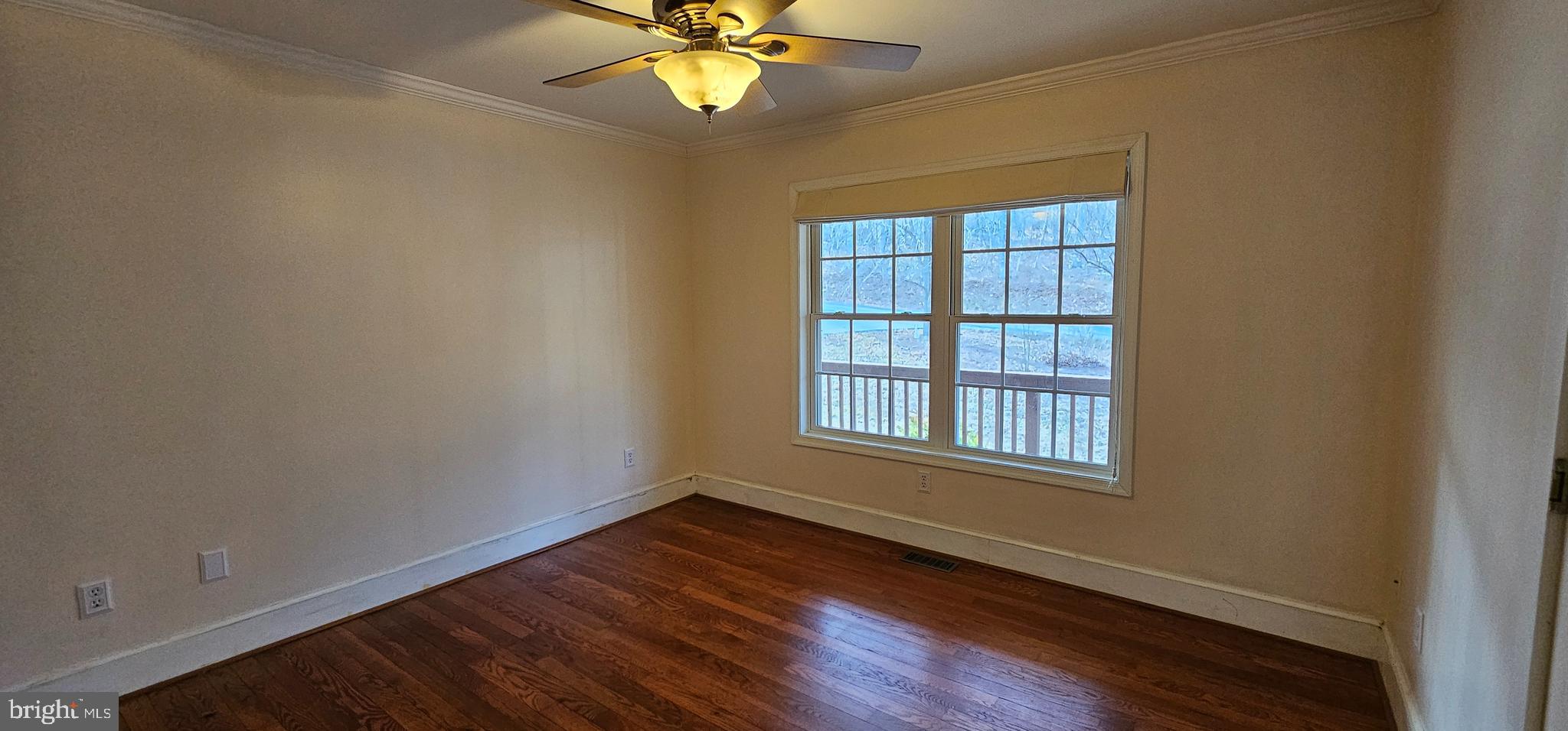 4078 Panhandle Road Front Royal, VA 22630 - Photo 12 of 23 an empty room with wooden floor fan and windows