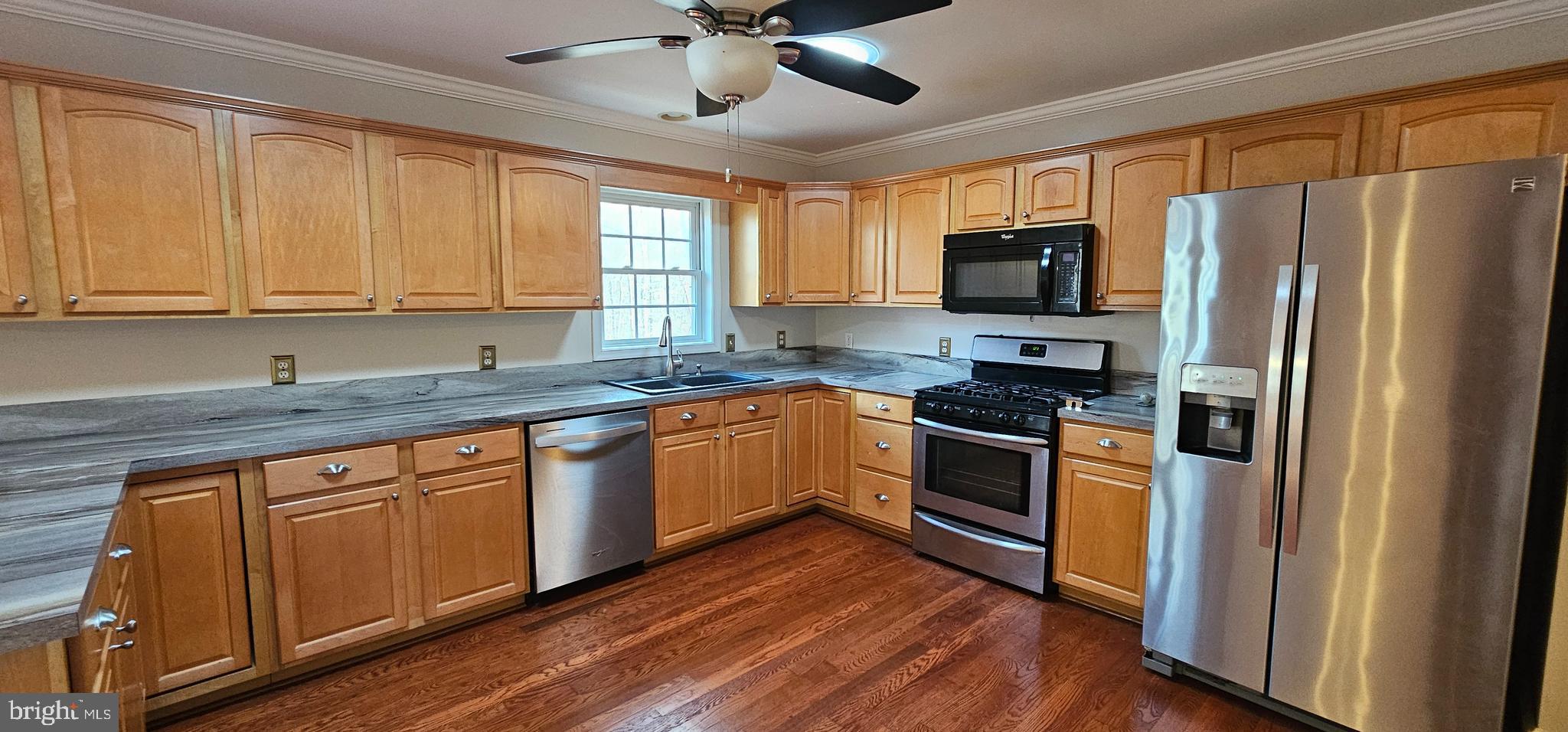 4078 Panhandle Road Front Royal, VA 22630 - Photo 3 of 23 a kitchen with stainless steel appliances granite countertop a refrigerator a sink a stove and white cabinets with wooden floor