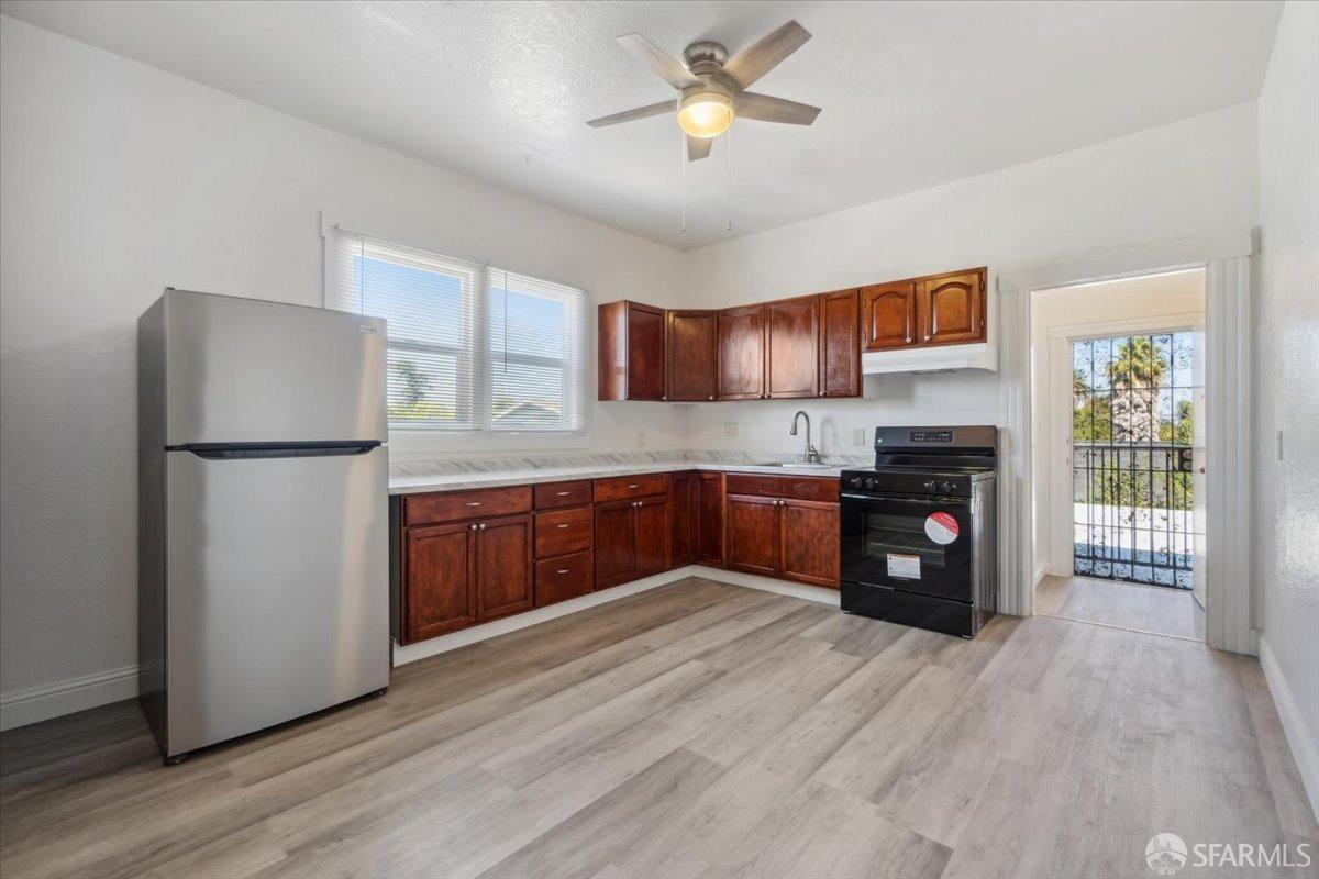 1309 80th Avenue Oakland, CA 94621 - Photo 29 of 75 a kitchen with granite countertop a refrigerator and a sink