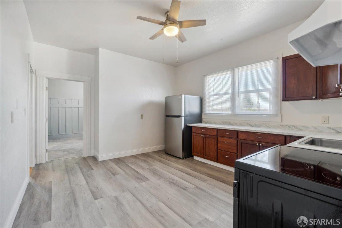 1309 80th Avenue Oakland, CA 94621 - Photo 31 of 75 a kitchen with a refrigerator and a sink
