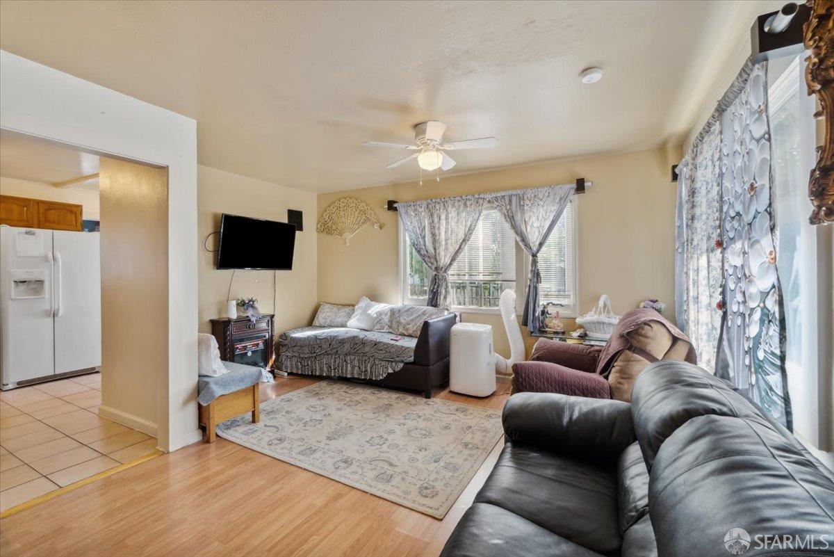 1309 80th Avenue Oakland, CA 94621 - Photo 36 of 75 a living room with furniture and a flat screen tv